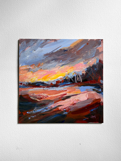 An abstract landscape painting on board, featuring expressive brushstrokes of orange, pink, yellow, blue, and brown, depicting a dramatic sky and ground