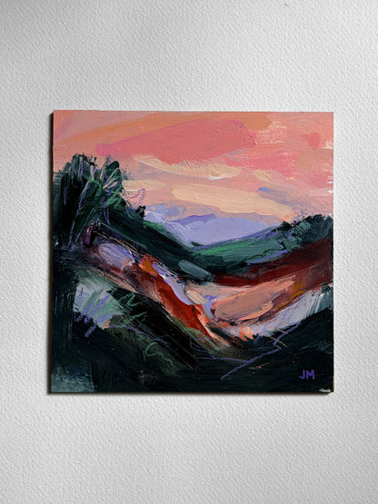 An abstract landscape painting on board, featuring a vibrant pink  sky, violet hills, and dark foreground brushstrokes, displayed on a textured white wall.