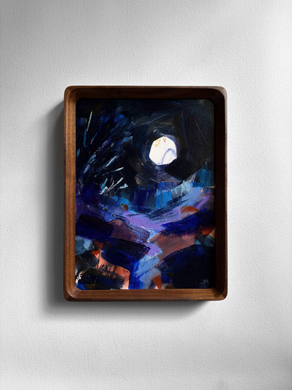 An abstract painting of a night sky with a bright moon, enclosed in a dark brown wooden frame and mounted on a light gray wall.