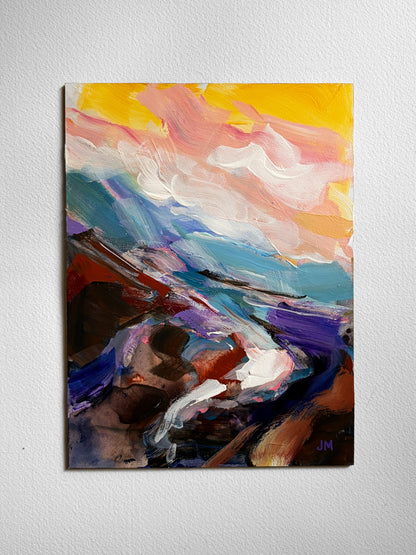 An abstract canvas painting featuring expressive brushstrokes in yellow, pink, blue, purple, brown, and white, displayed on a textured white wall.