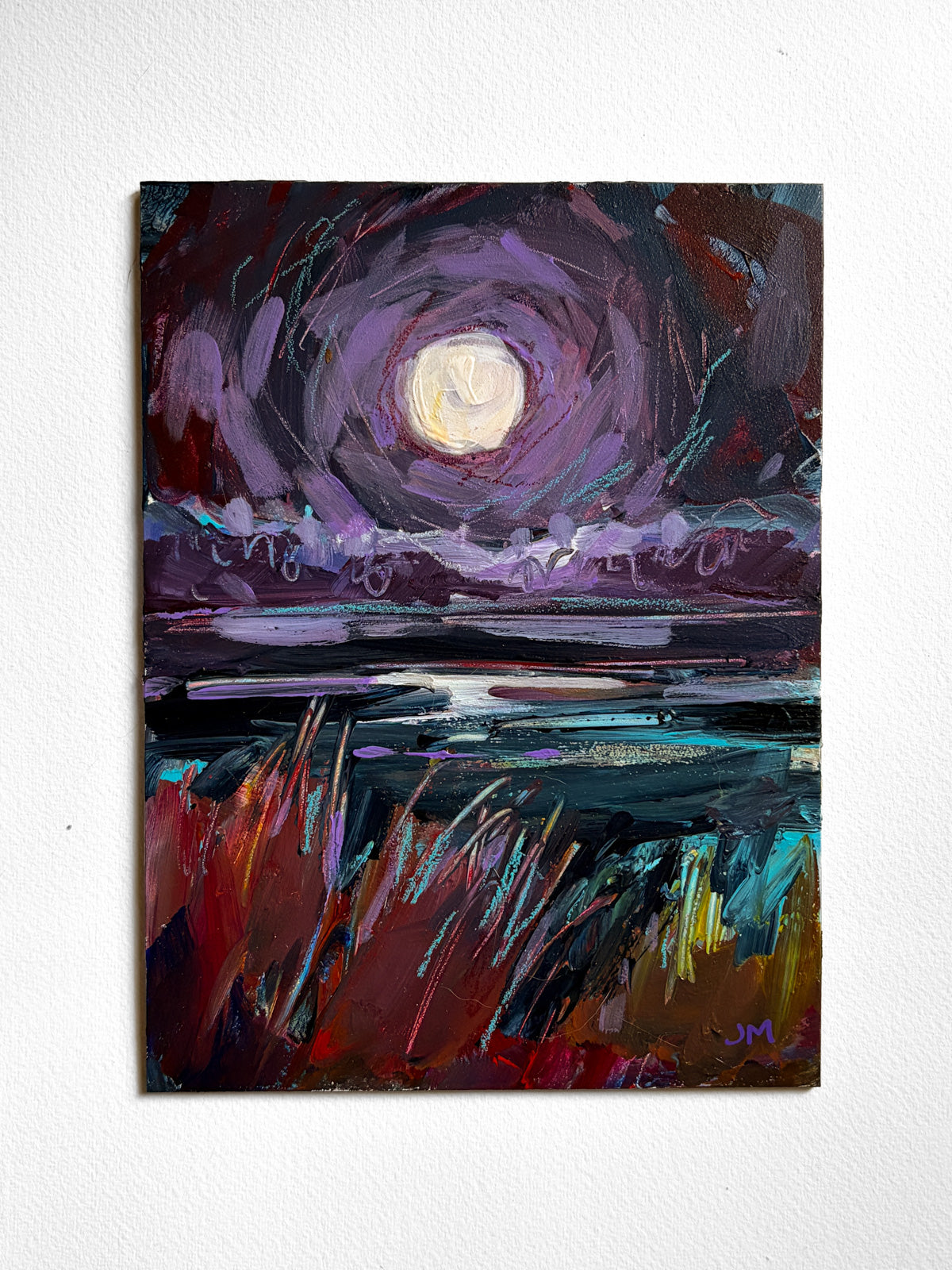 An expressive painting of a moonlit landscape, featuring a glowing pale moon in a swirling violet sky over reflective water with red, teal, and gold brushstrokes in the foreground, displayed on a white wall.