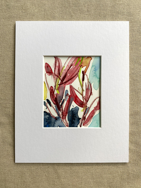 Matted original artwork with a colorful abstract design of red leaves on a textured beige background