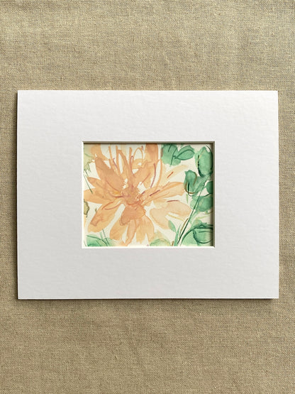 Peach and green floral painting  in a white mat on beige textured background