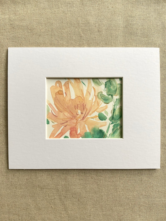 Matted artwork of a peach and green floral design on a textured beige background