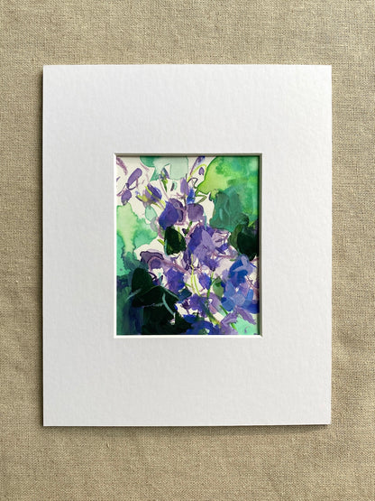Floral abstract artwork with purple and green colors in white mat on beige textured background