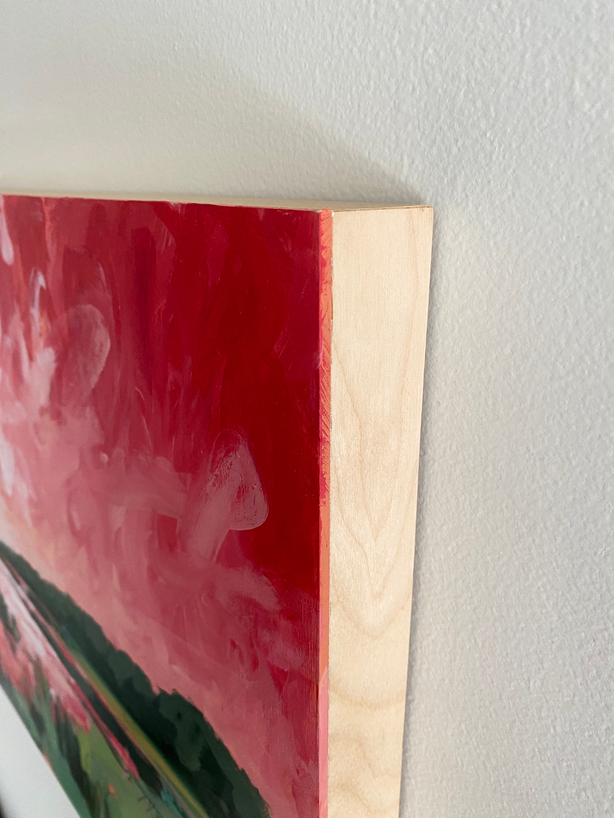 Corner view of red landscape painting
